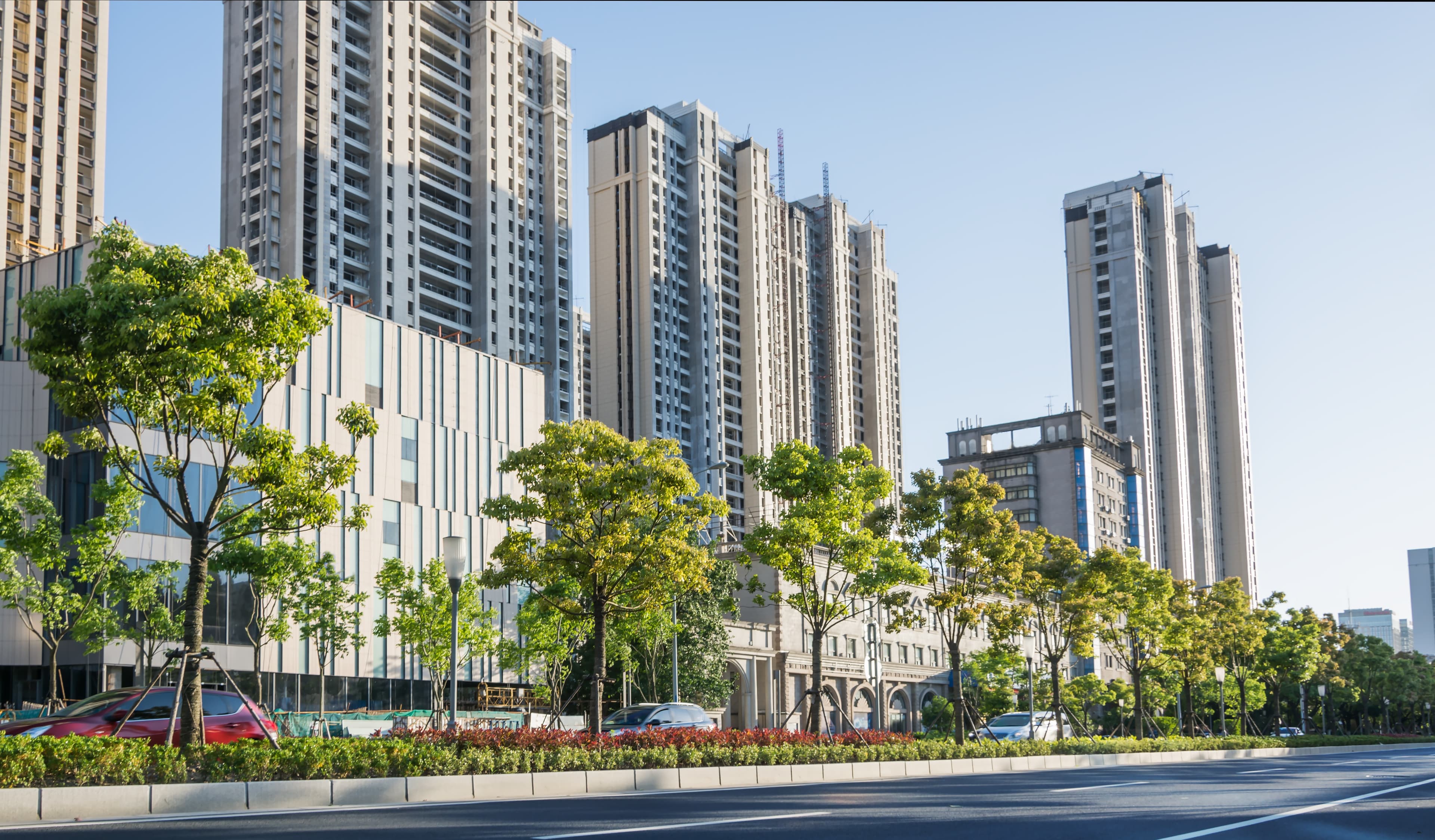 Original property consultant in Pune standing near modern apartment buildings