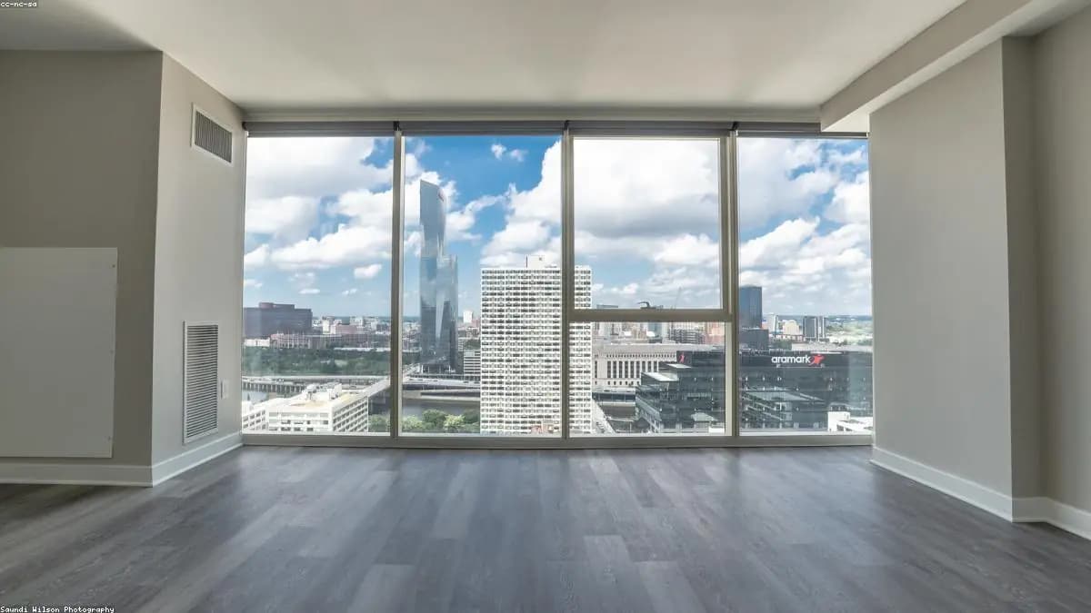 Luxurious penthouse interior with floor-to-ceiling windows overlooking the ocean
